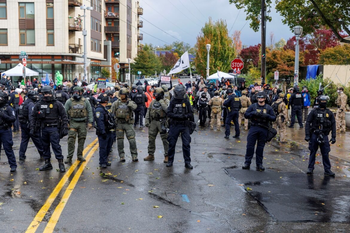 PHOTO: People participate in a protest organized by Portland Against Deportations at the ICE facility in Portland